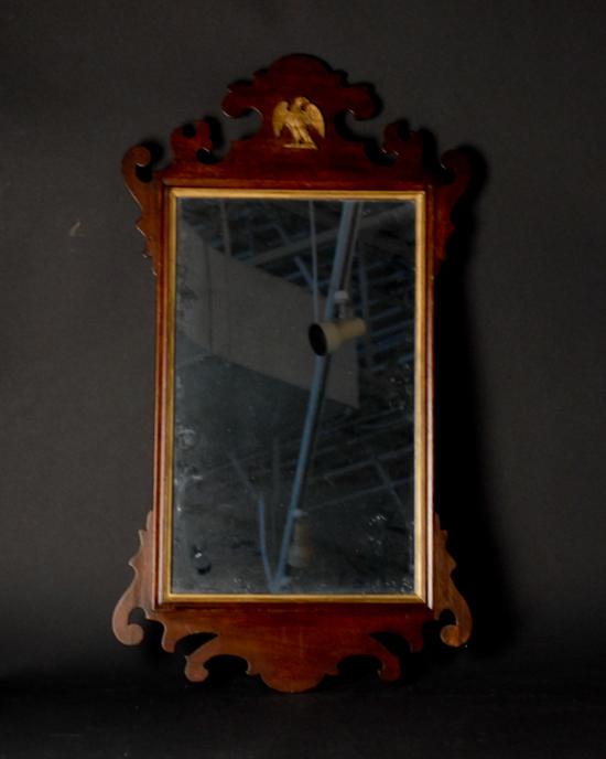 Appraisal: A Chippendale-style Looking Glass having a scrolled crests with applied