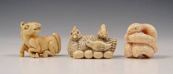 Appraisal: PIECE JAPANESE CARVED IVORY ANIMAL FIGURE NETSUKE To include Coiled