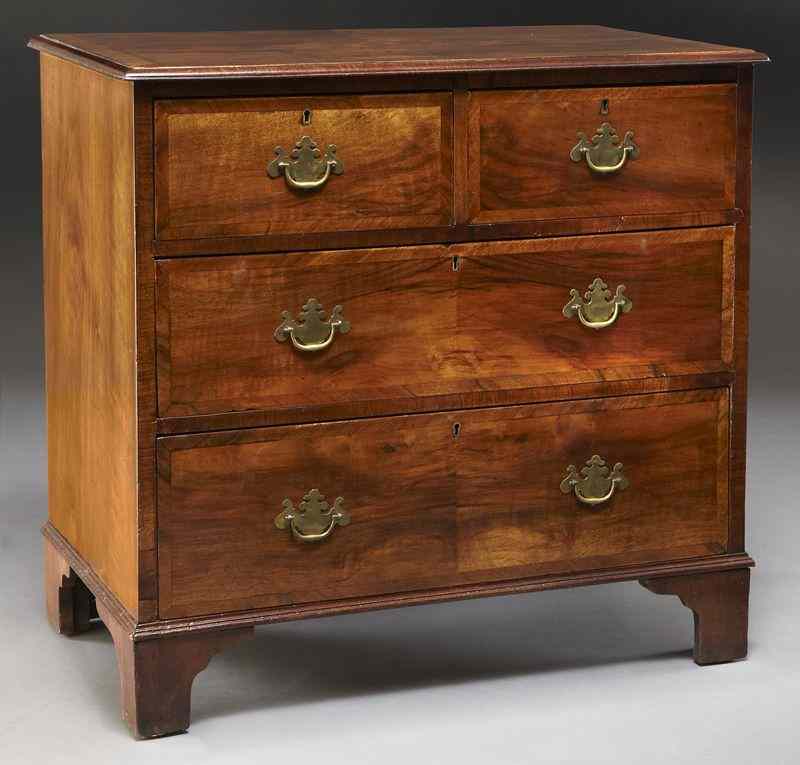 Appraisal: Small Georgian walnut chest of drawers consisting of two short