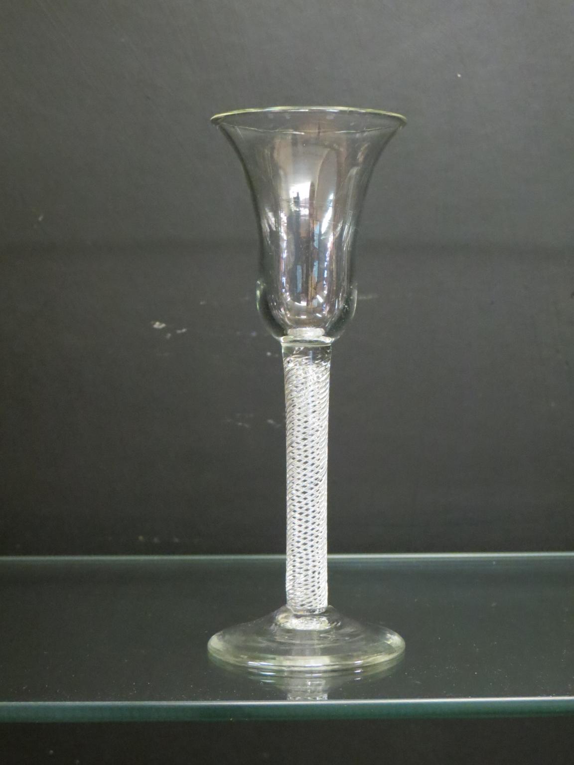 Appraisal: An th century English wine glass bell-bowl on single-series air-twist