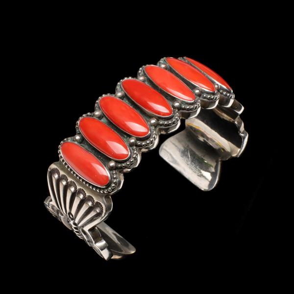 Appraisal: AN ERNEST BEGAY HEAVY STERLING CUFF WITH CORALThe skillfully worked