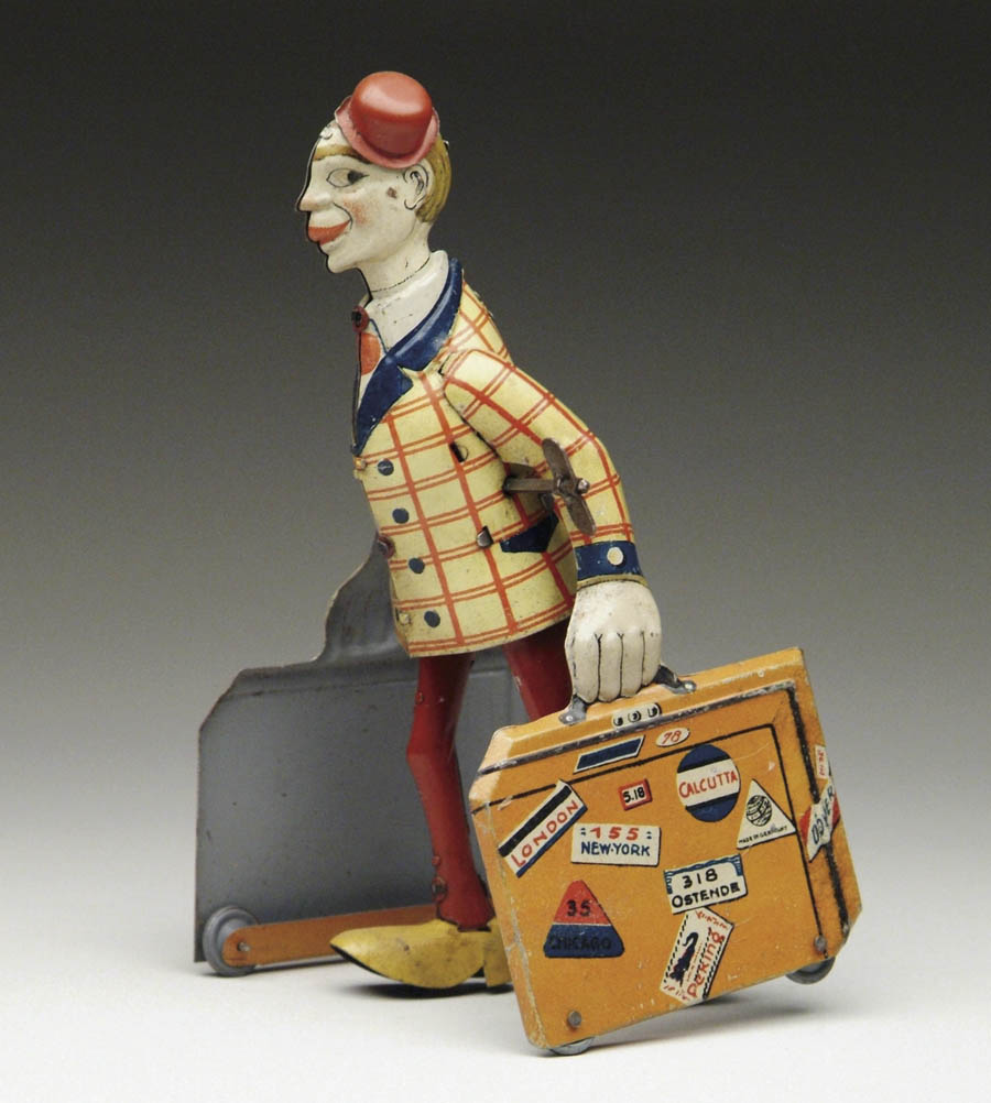 Appraisal: DISTLER WINDUP GENTLEMAN CARRYING SUITCASES Brightly lithographed gent with striped