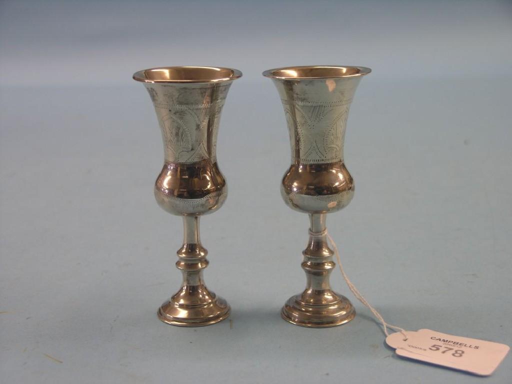 Appraisal: A pair of small engraved silver pedestal cups Birmingham in