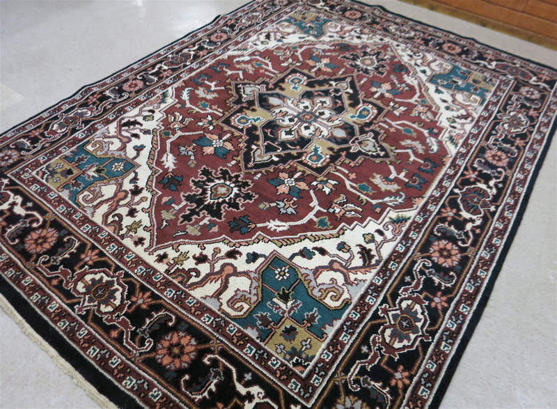 Appraisal: HAND KNOTTED ORIENTAL CARPET Indo-Heriz floral and central floral medallion