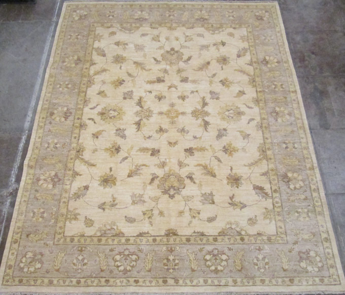 Appraisal: HAND KNOTTED ORIENTAL CARPET Pakistani Persian featuring a rectangular khaki