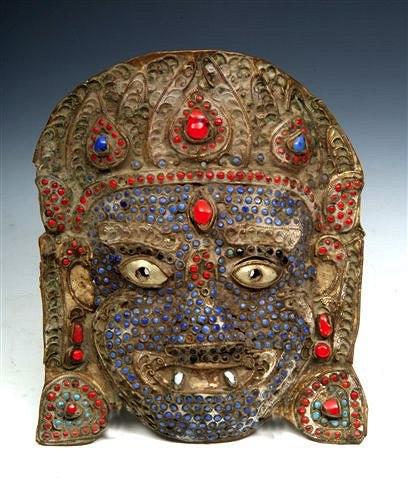 Appraisal: AN ANTIQUE INDIAN METAL MASK inset coloured stones with stylised