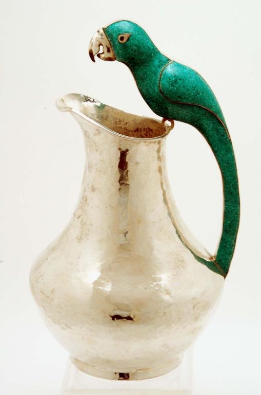 Appraisal: A Mexican hand-hammered silver plated alpaca pitcher terminating in a