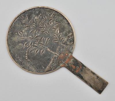 Appraisal: A Chinese Bronze Hand Mirror The plaque of the mirror