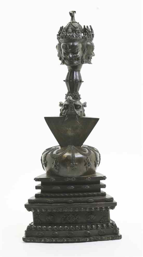 Appraisal: A Nepalese Patinated Bronze Statue in two parts the top