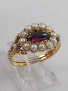 Appraisal: A garnet and pearl ring set in yellow metal tests