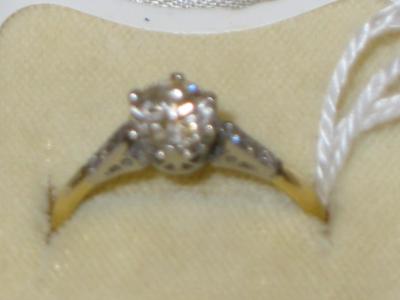 Appraisal: A SOLITAIRE DIAMOND RING claw set with diamond set shoulders