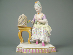 Appraisal: Meissen figure of a seated woman with a parrot in