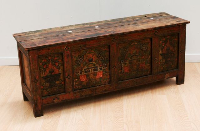 Appraisal: A Tibetan low storage cabinet two outer panels depicting a