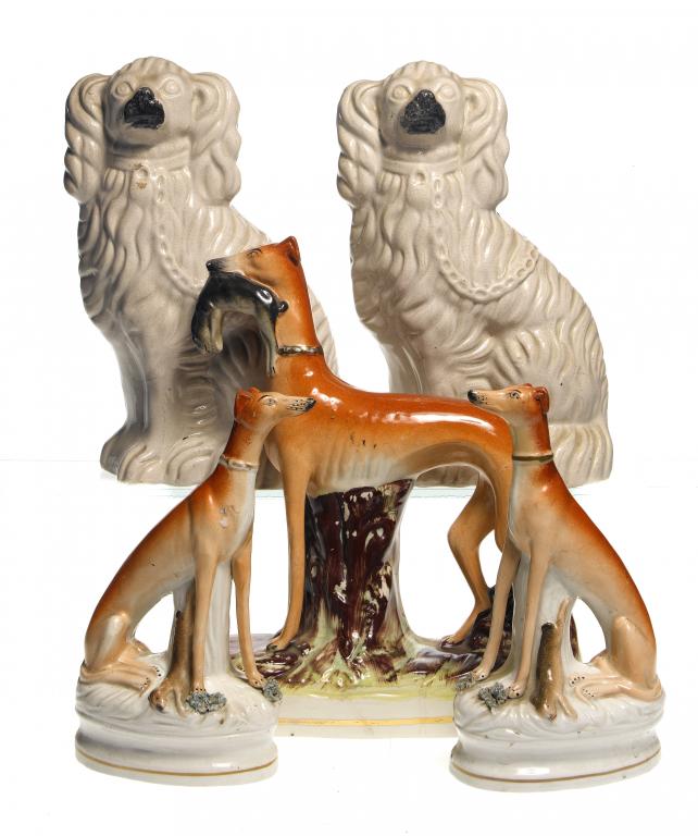 Appraisal: ONE AND A PAIR OF STAFFORDSHIRE EARTHENWARE MODELS OF GREYHOUNDS