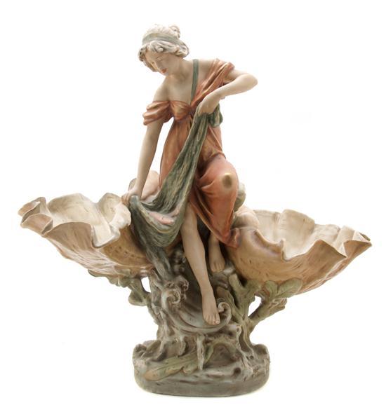 Appraisal: A Royal Dux Figurine depicting a fisherwoman flanked by seashells