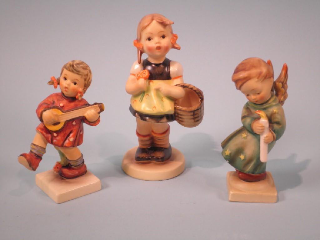 Appraisal: Three Hummel figures one carrying a basket another playing a