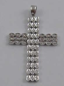 Appraisal: A hallmarked carat white gold cross pendant set with diamonds