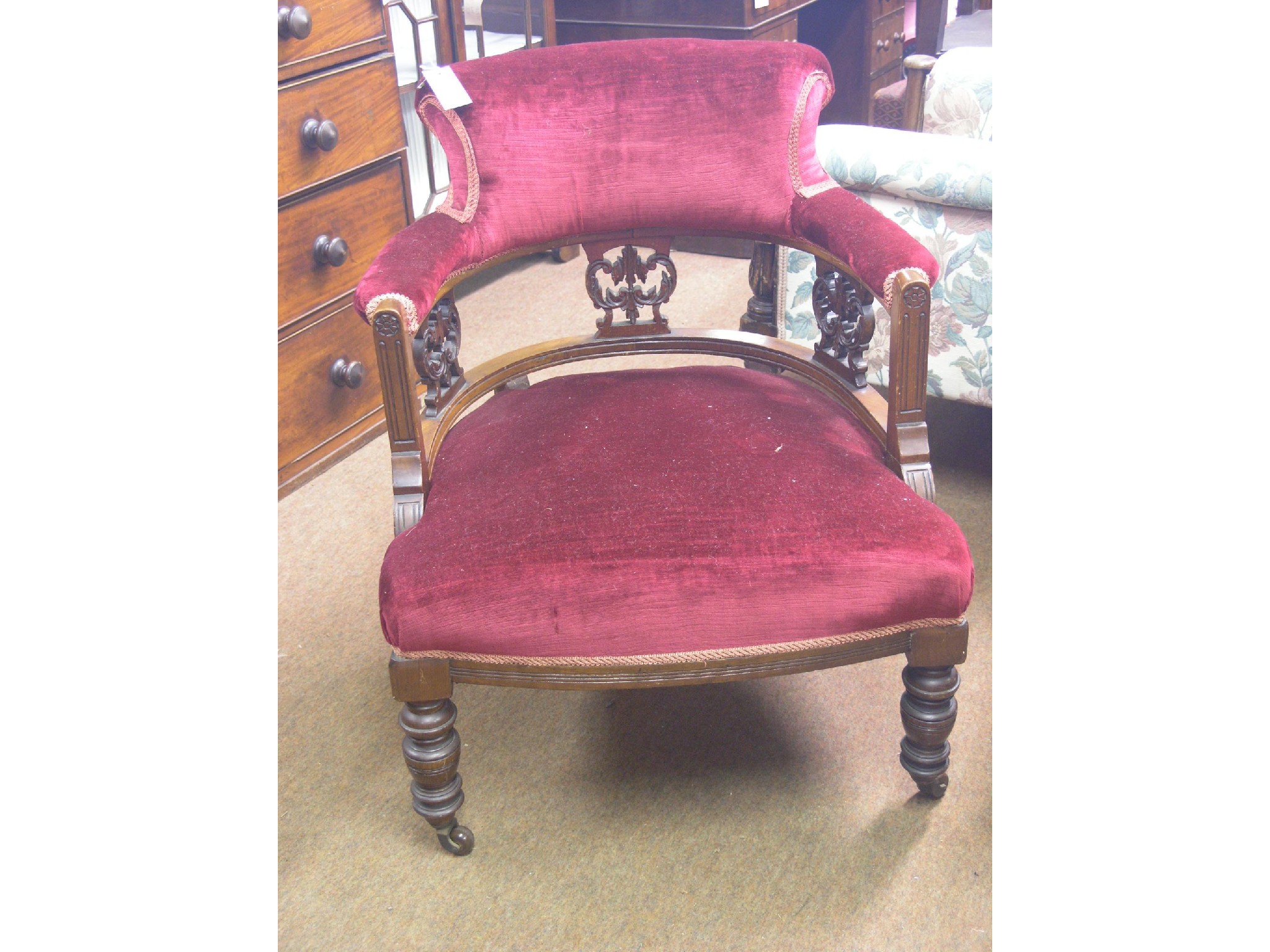 Appraisal: A late Victorian mahogany tub-shape elbow chair with carved splats