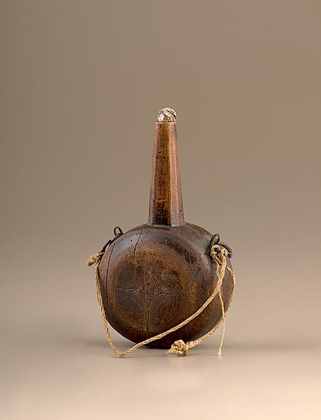 Appraisal: CARVED WOOD POWDER FLASK A carved wooden powder flask likely