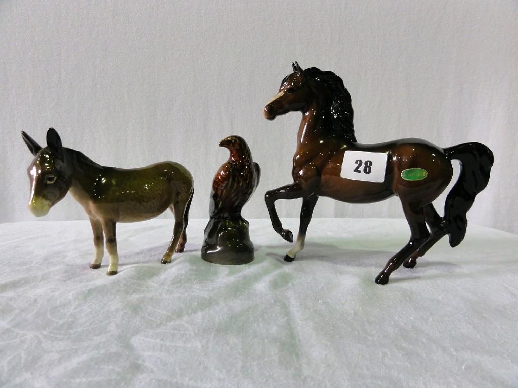 Appraisal: A Beswick model of a trotting brown pony together with