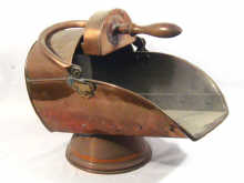 Appraisal: A copper coal scuttle with fitted shovel