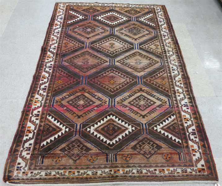 Appraisal: PERSIAN TRIBAL CARPET repeating diamond and half-diamond medallion design overall