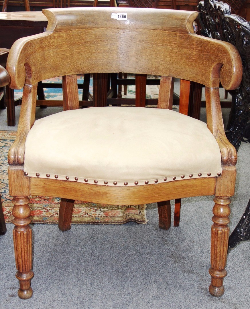 Appraisal: An early th century French light oak tub back desk