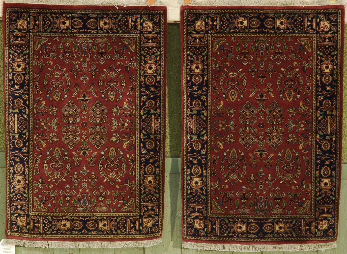 Appraisal: TWO ORIENTAL RUGS IDENTICAL FERAHAN SAROUK-DESIGN MATS ' x '