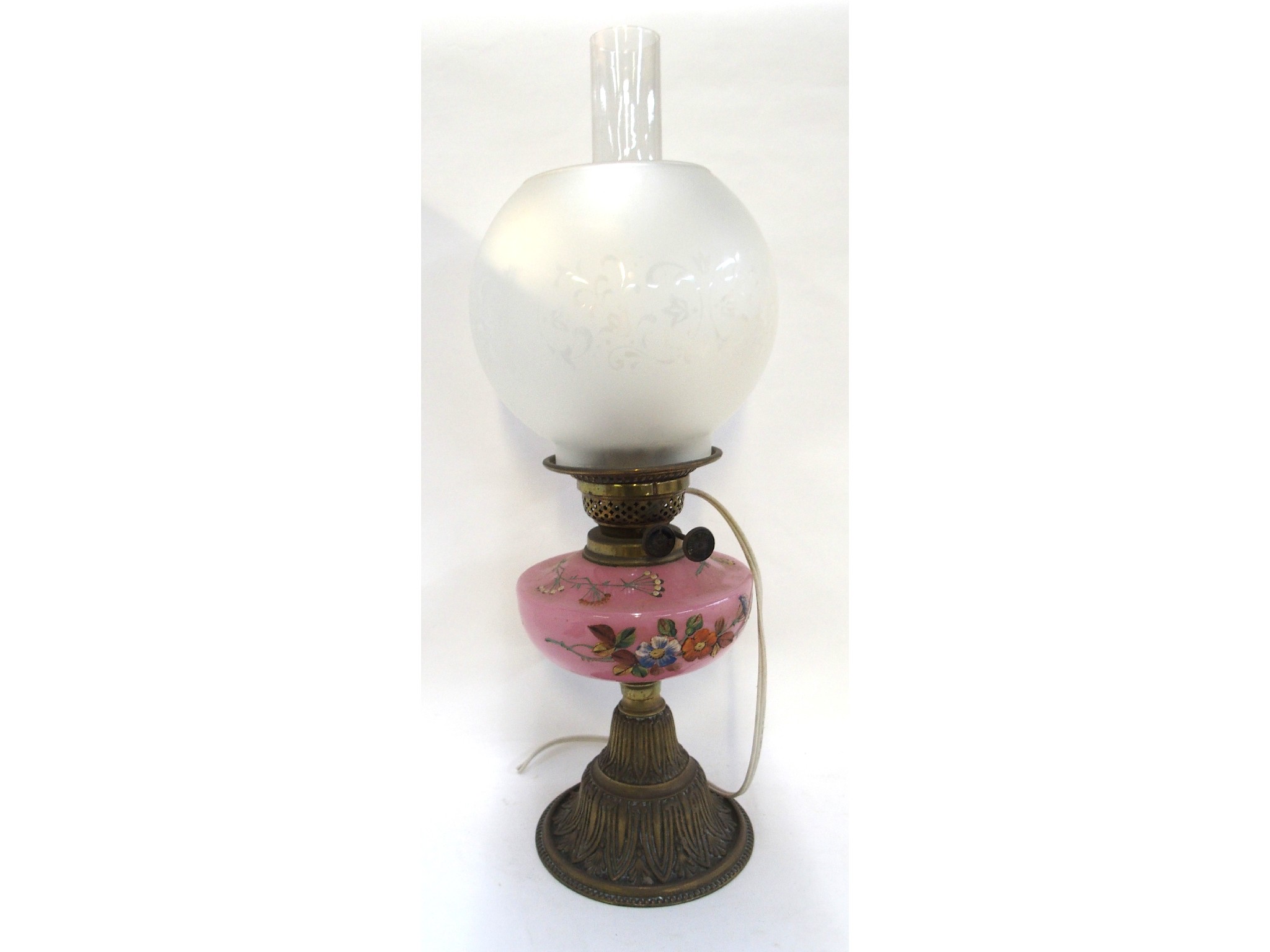 Appraisal: A Victorian paraffin lamp with pink glass reservoir handpainted with