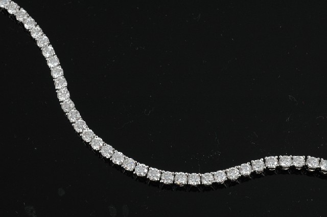 Appraisal: A DIAMOND LINE BRACELET Comprising forty nine round brilliant cut