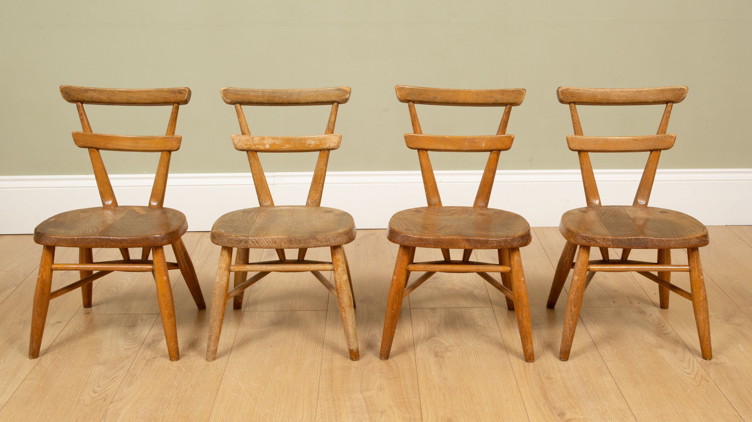 Appraisal: A set of four child-sized Ercol light elm chairs with