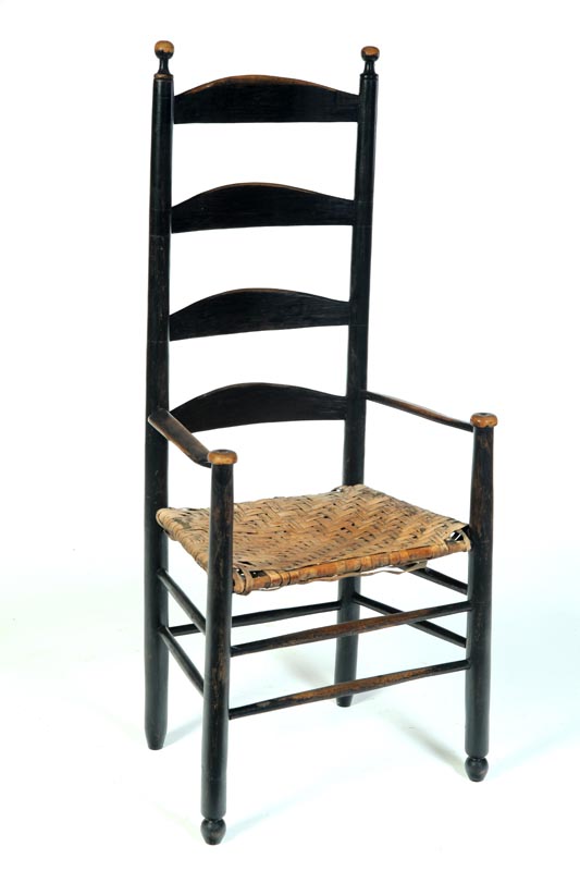 Appraisal: LADDERBACK ARMCHAIR American th century hardwood Old black repaint Feet