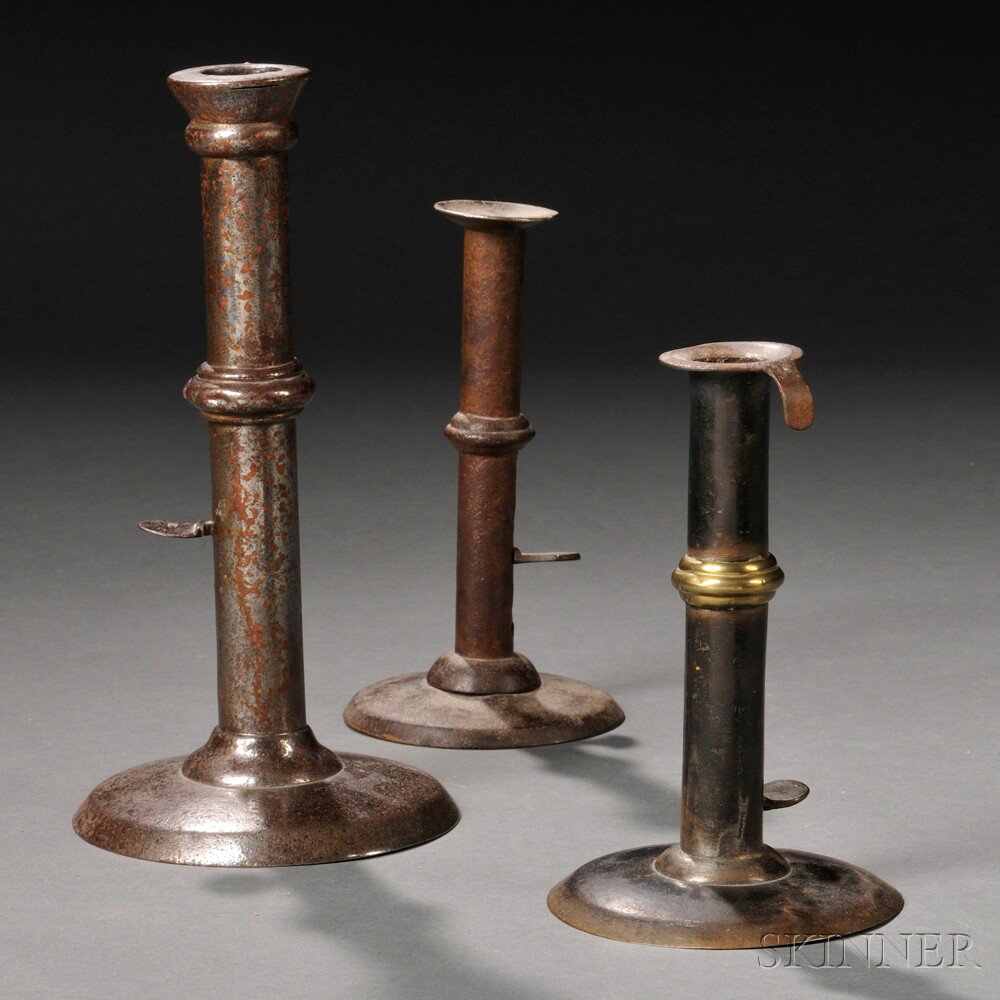 Appraisal: Three Sheet Iron Push-up Hogscraper Candlesticks America early th century