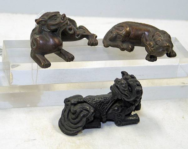 Appraisal: Three bronze paper weights depicting recumbent animals The first a