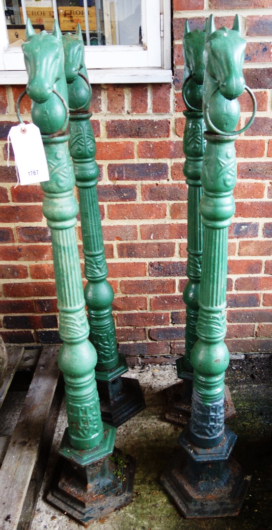 Appraisal: A set of four green painted cast iron horse tether