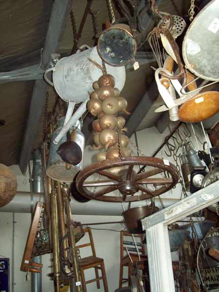 Appraisal: A LARGE COLLECTION OF HANGING SUNDRIES METAL CANISTER WAGON WHEELS