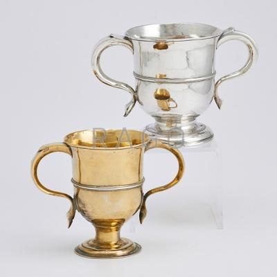 Appraisal: TWO ENGLISH STERLING TROPHY CUPS TH C Banded on flared