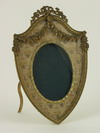 Appraisal: BRASS FRAME - French Embossed Brass shield-form standing photo frame