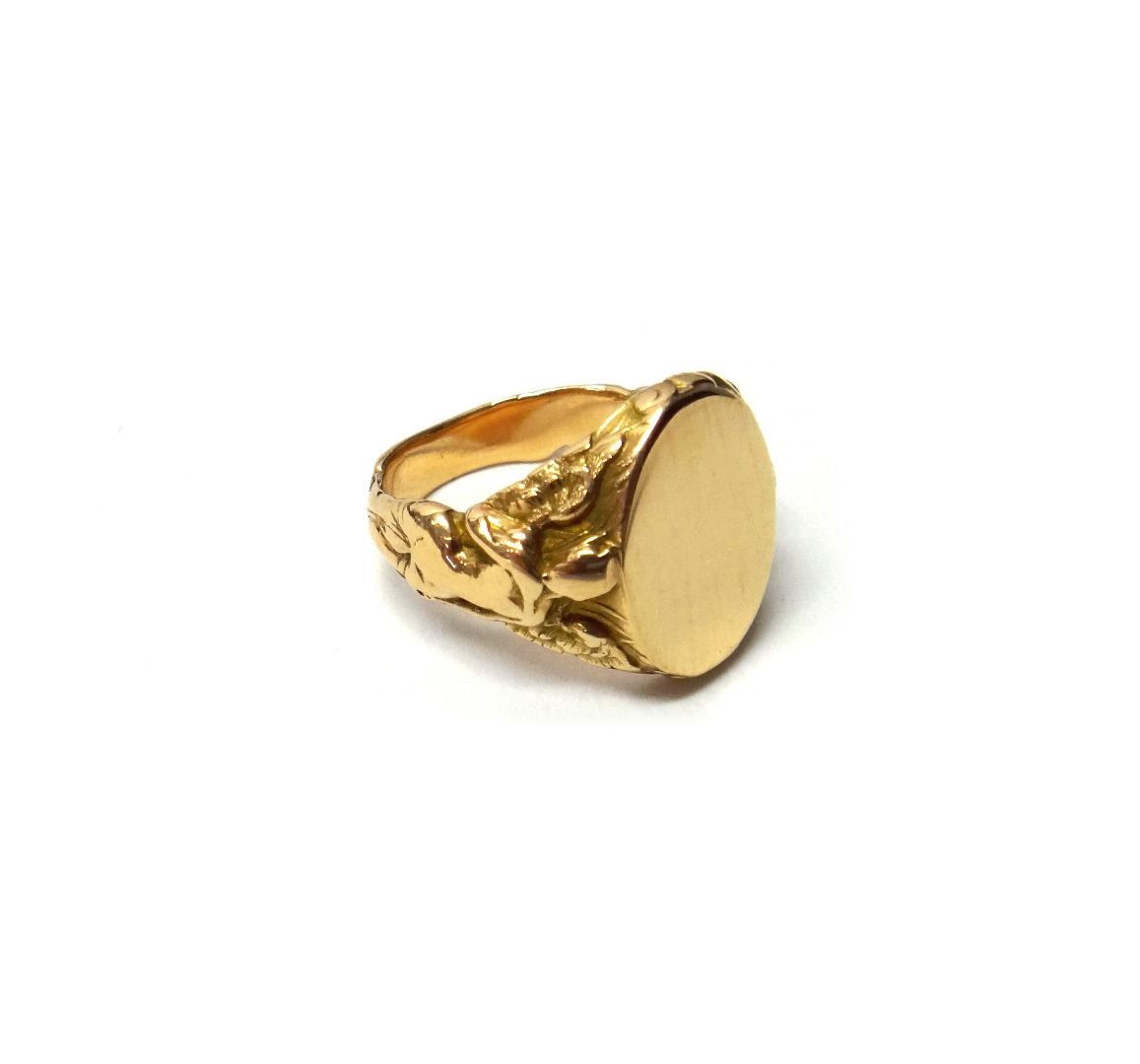 Appraisal: A gold signet ring each shoulder designed as a classical