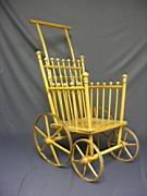 Appraisal: DOLL STROLLER WITH BALL AND STICK MOTIF Seat is carved