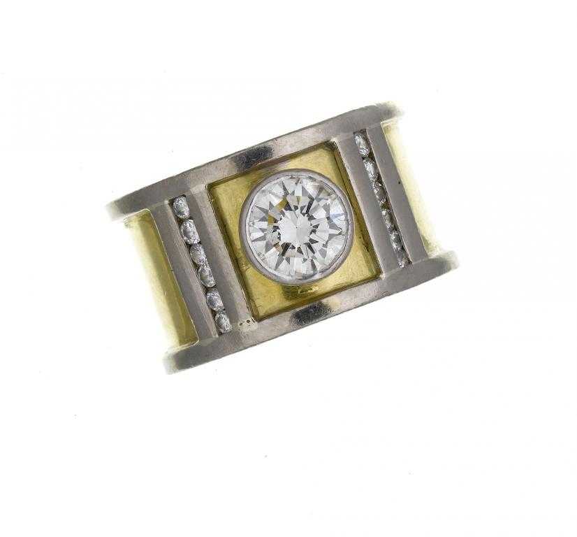 Appraisal: A DIAMOND RING the broad platinum and gold band surmounted