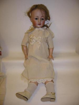 Appraisal: A Carl Harmus bisque head doll with blue glass eyes