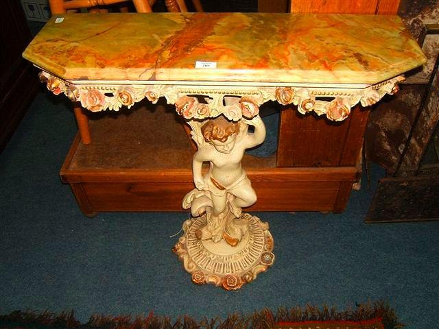 Appraisal: a pier table the painted base with carved cherub support