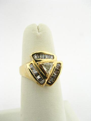 Appraisal: K yellow gold ring with trillion cut center diamond and