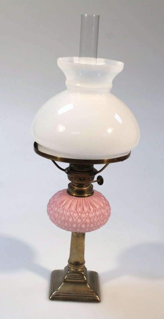 Appraisal: An early thC brass and pink glass oil lamp with