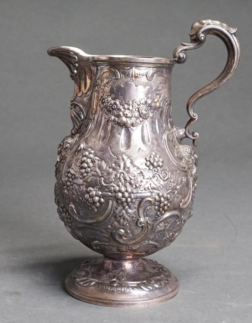 Appraisal: VICTORIAN REPOUSSE SILVER PITCHER MAKERS MARK OBSCURE LONDON OZTVictorian Repousse