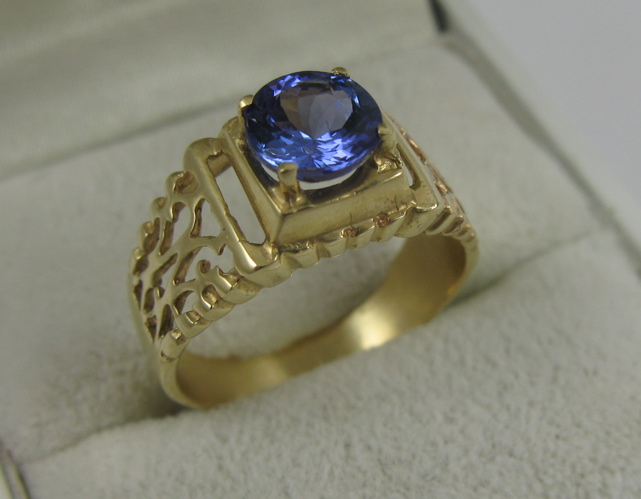 Appraisal: TANZANITE AND K GOLD SOLITAIRE RING the pierced four-prong setting