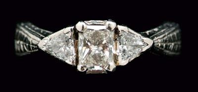 Appraisal: Diamond engagement ring central radiant-cut flanked by triangle brilliant-cut total