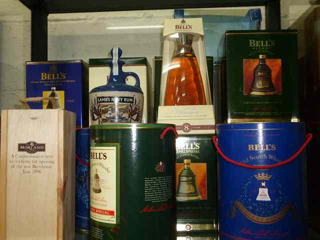 Appraisal: A COLLECTION OF APPROXIMATELY TWENTY BELLS WHISKEY COMMEMORATIVE DECANTERS to