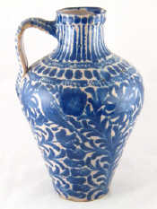 Appraisal: A blue and white stoneware pot with strap handle probably